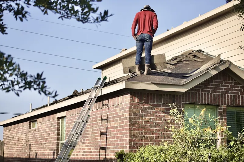 Professional roofer working on a residential roof in Rock Creek Park